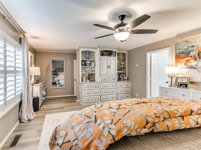 bedroom with crown molding, multiple windows, and light hardwood / wood-style flooring