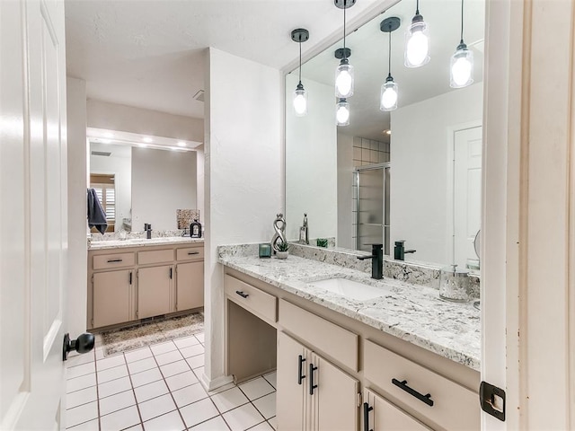 bathroom with vanity, a shower with shower door, and tile patterned floors