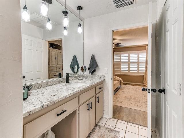 bathroom with tile patterned flooring, vanity, and a baseboard radiator