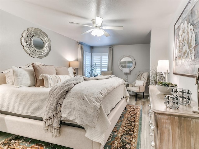 bedroom with hardwood / wood-style flooring and ceiling fan