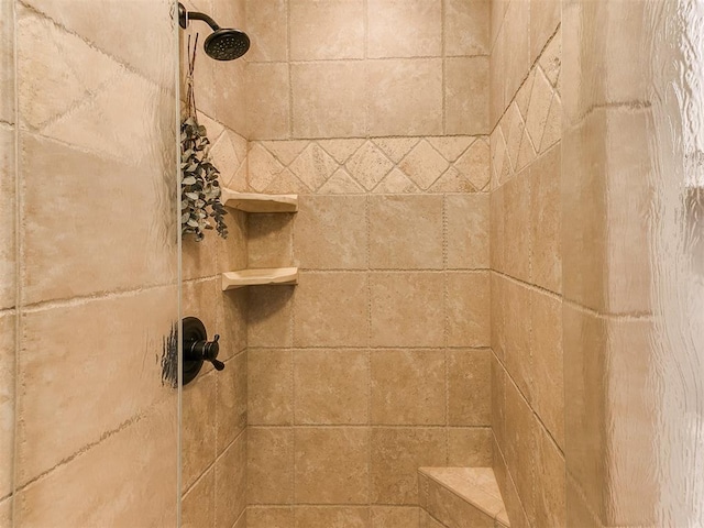 interior details with a tile shower