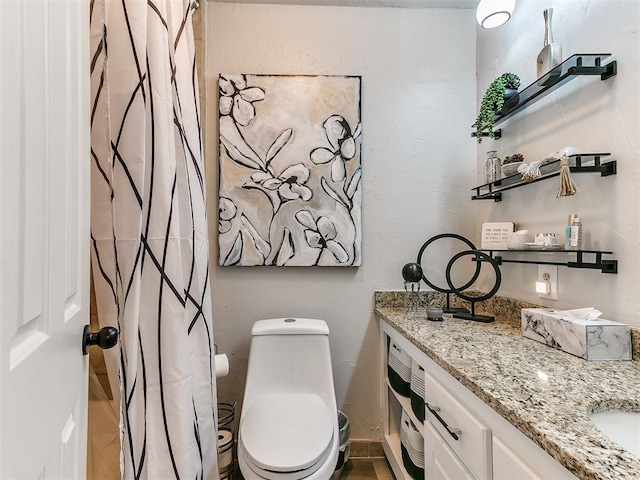 bathroom with vanity and toilet