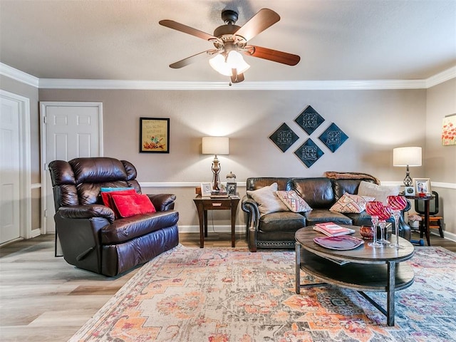 living room featuring ornamental molding, ceiling fan, and light hardwood / wood-style floors