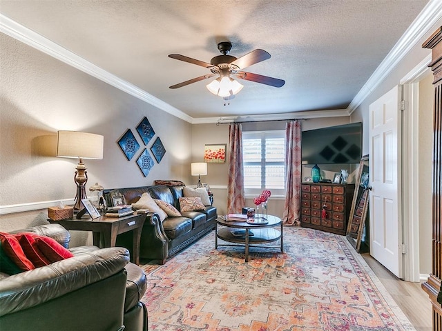 living room featuring crown molding, a textured ceiling, ceiling fan, and light wood-type flooring