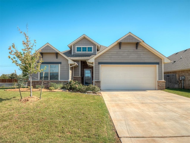 craftsman house featuring a garage and a front lawn