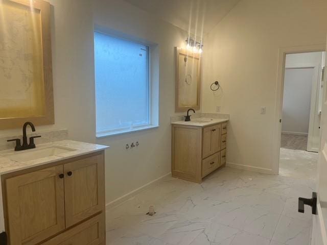 bathroom featuring lofted ceiling and vanity