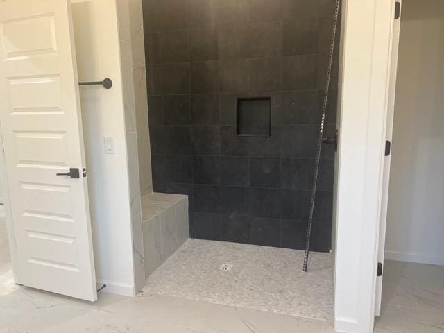 bathroom featuring tiled shower