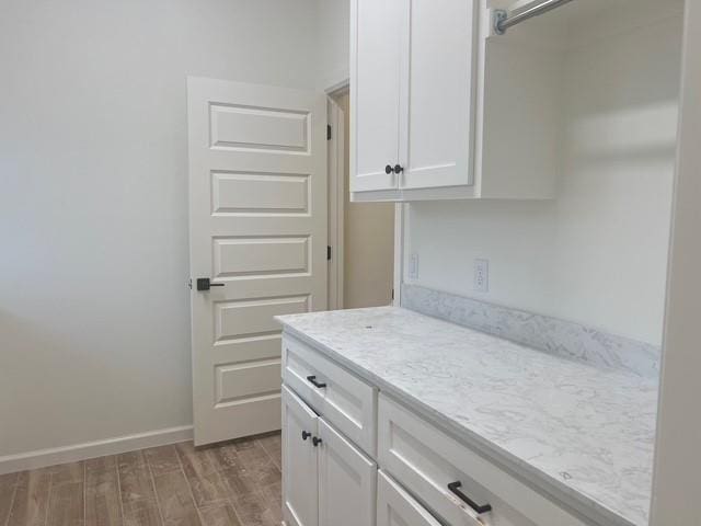 laundry area with light hardwood / wood-style floors