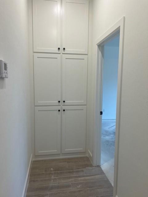 hallway with dark hardwood / wood-style floors