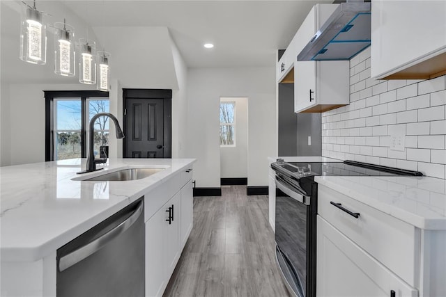 kitchen featuring wall chimney exhaust hood, decorative light fixtures, stainless steel dishwasher, range with electric cooktop, and white cabinets