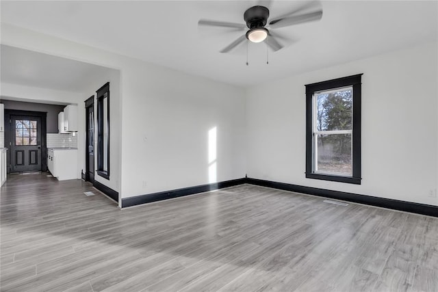 spare room featuring ceiling fan and light wood-type flooring