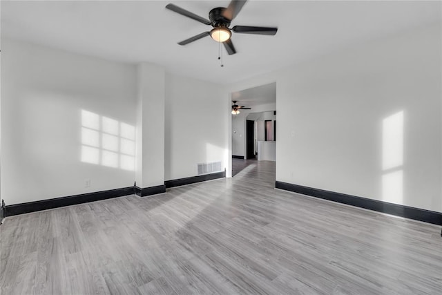 spare room featuring light hardwood / wood-style flooring and ceiling fan