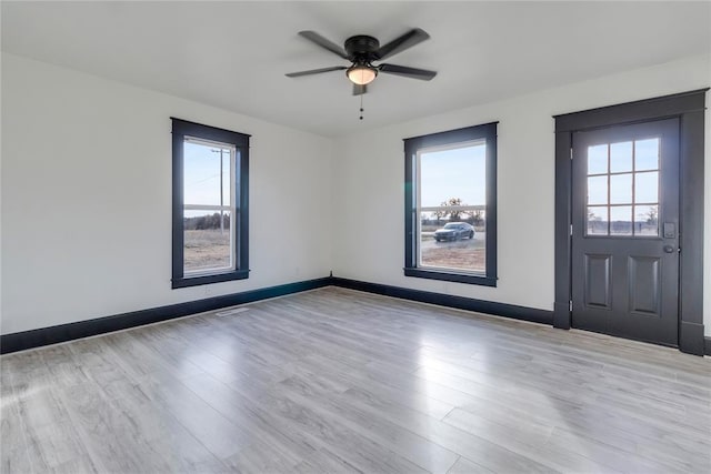 entryway featuring plenty of natural light, ceiling fan, and light hardwood / wood-style flooring