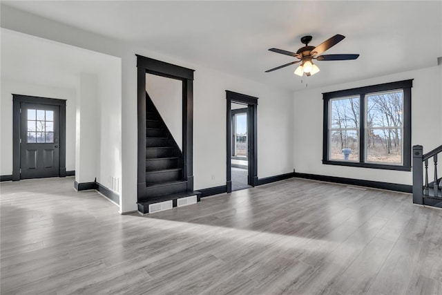 entrance foyer with ceiling fan and light wood-type flooring