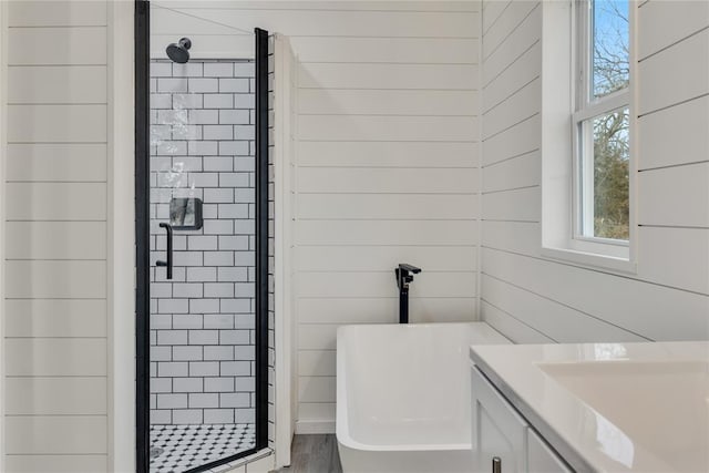 bathroom with vanity and shower with separate bathtub