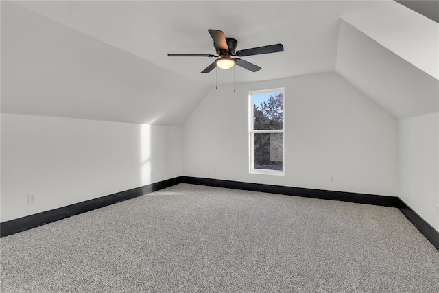 additional living space featuring vaulted ceiling, carpet, and ceiling fan