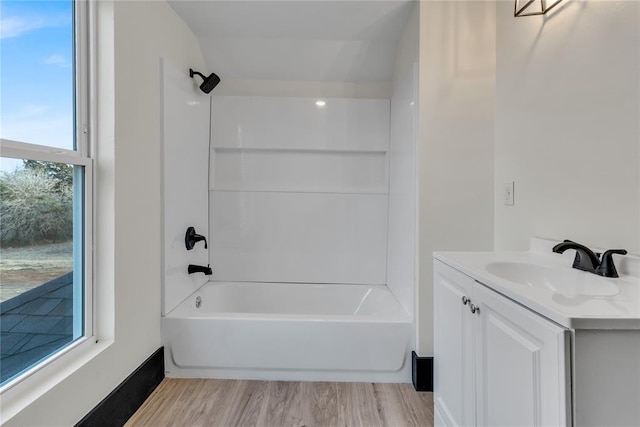 bathroom with vanity, hardwood / wood-style floors, and shower / bathtub combination