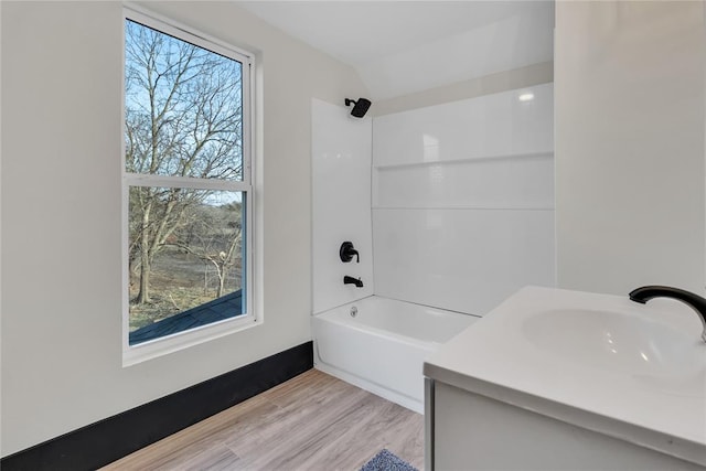 bathroom featuring vanity, plenty of natural light, shower / tub combination, and wood-type flooring