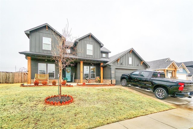 view of front facade with a garage, a front lawn, and covered porch