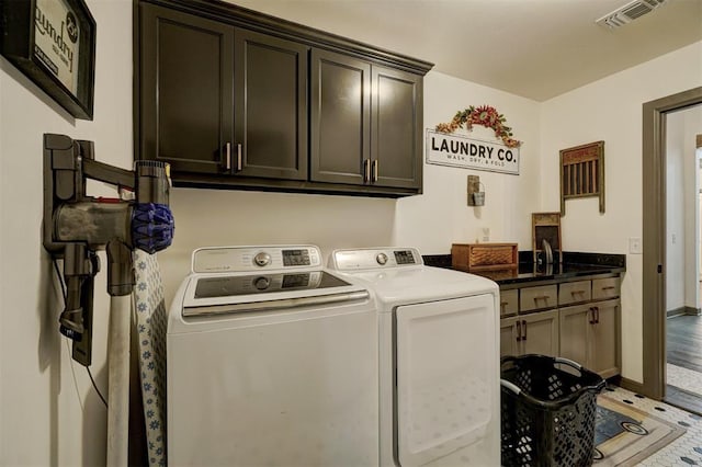 laundry room featuring cabinets and washing machine and clothes dryer