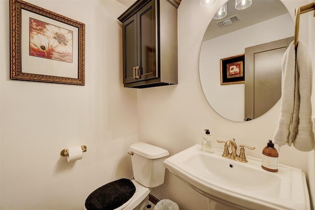 bathroom featuring toilet and sink