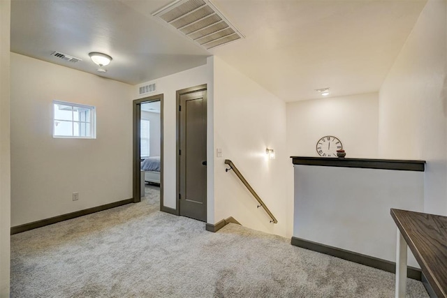 corridor with light colored carpet