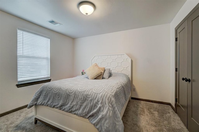 bedroom with dark colored carpet