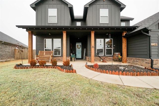 view of front of property with covered porch and a front lawn