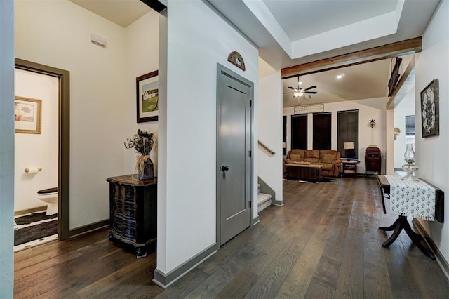 hall featuring beam ceiling and dark hardwood / wood-style flooring