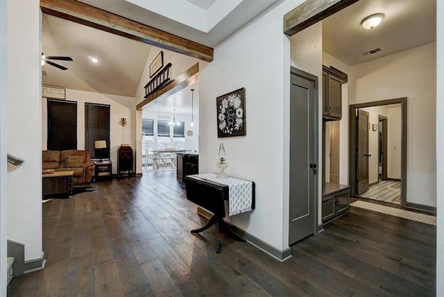 corridor with lofted ceiling with beams, dark hardwood / wood-style floors, and a chandelier