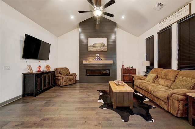 living room with hardwood / wood-style flooring, vaulted ceiling, a large fireplace, and ceiling fan