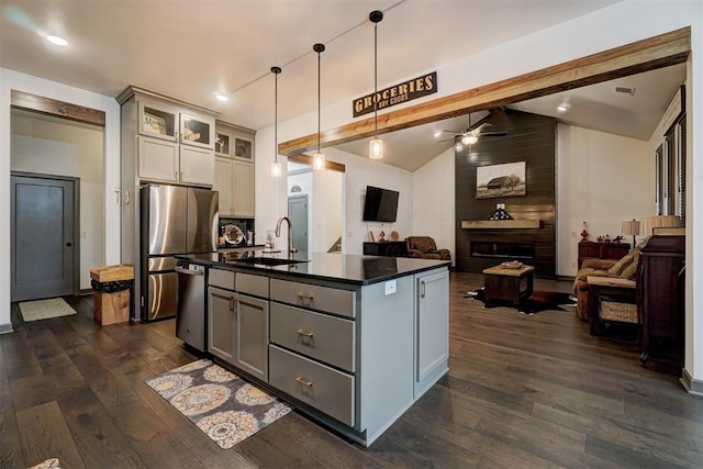 kitchen featuring pendant lighting, sink, gray cabinetry, and a kitchen island with sink