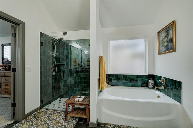 bathroom with plus walk in shower and tile patterned flooring