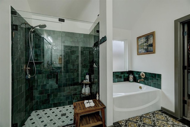 bathroom with vaulted ceiling and shower with separate bathtub