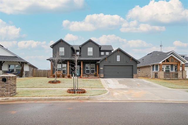 view of front facade featuring a front yard, fence, driveway, an attached garage, and board and batten siding