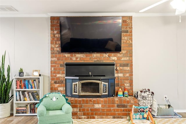 interior space featuring a brick fireplace, crown molding, and hardwood / wood-style flooring