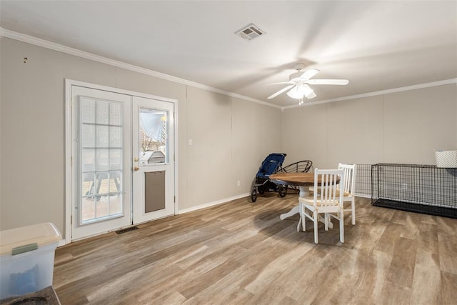 dining area featuring crown molding, ceiling fan, and light hardwood / wood-style floors