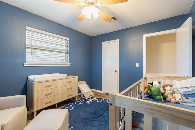 bedroom featuring ceiling fan and dark hardwood / wood-style floors