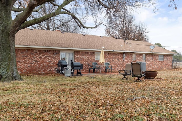 rear view of house with a yard and a patio