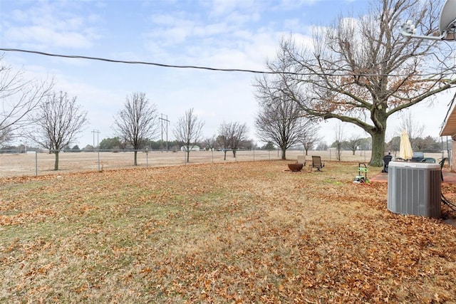 view of yard with a rural view and central AC unit