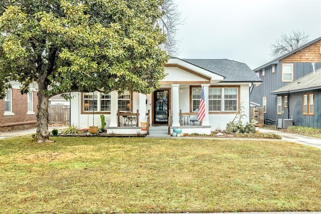 view of front of home with a porch, central AC unit, and a front yard