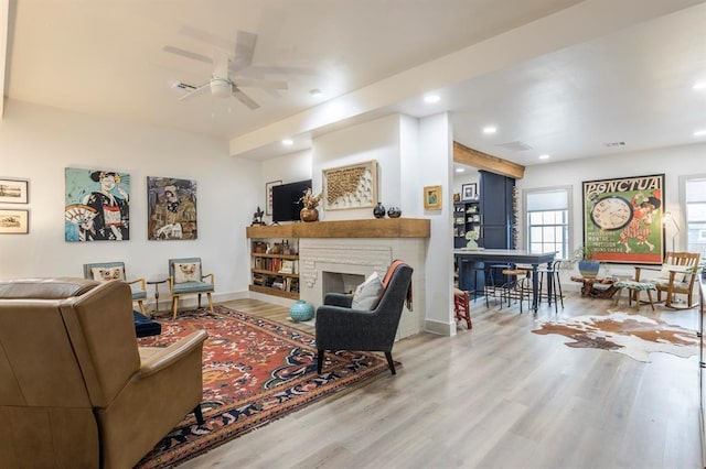 living room with hardwood / wood-style flooring and ceiling fan