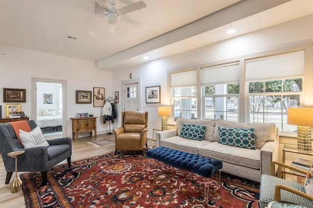 living room featuring ceiling fan and light wood-type flooring