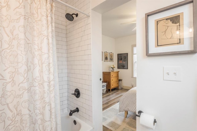 bathroom featuring shower / tub combo with curtain and hardwood / wood-style floors