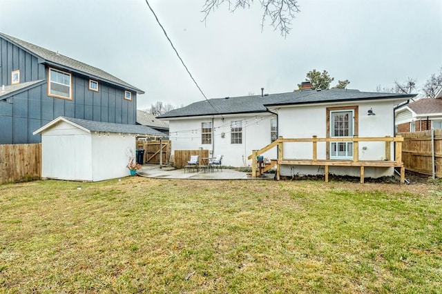 rear view of property with a patio, a storage unit, and a lawn