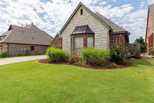 view of side of home featuring a lawn