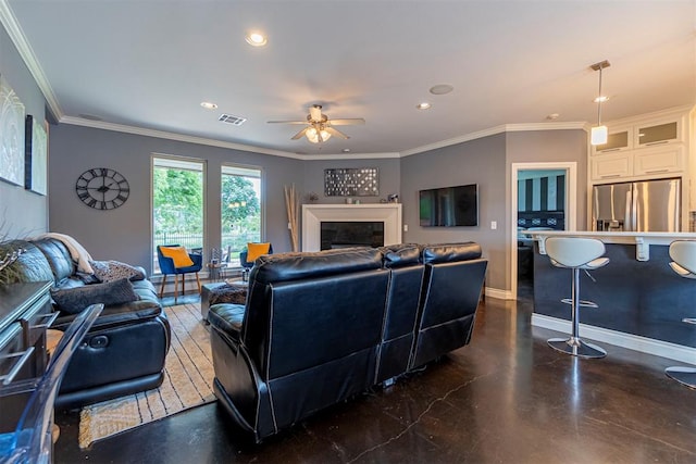 living room with ceiling fan and ornamental molding