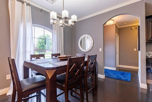 dining space featuring crown molding and a chandelier