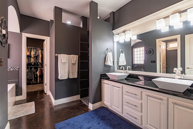 bathroom featuring vanity, concrete floors, and walk in shower