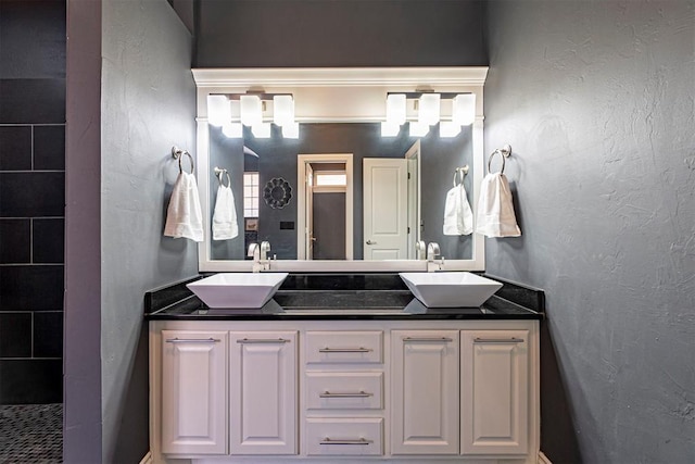 bathroom with vanity and a shower